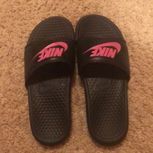 Pink and black Nike slides